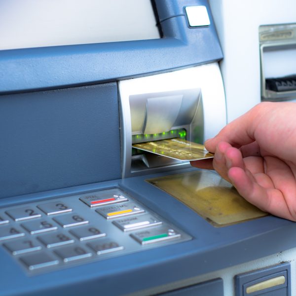 Hand inserting ATM credit card